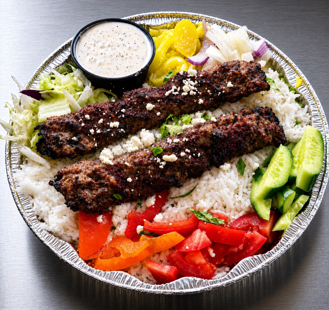 Grilled kabob over seasoned rice with fresh vegetables